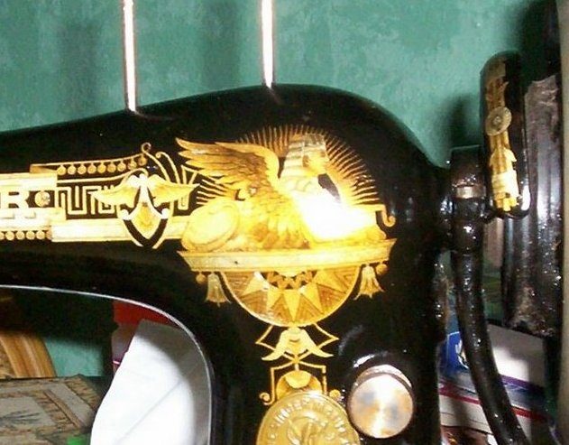 The gold Sphinx decals on the arm of an old Singer Model 27. Not the machine in the story.