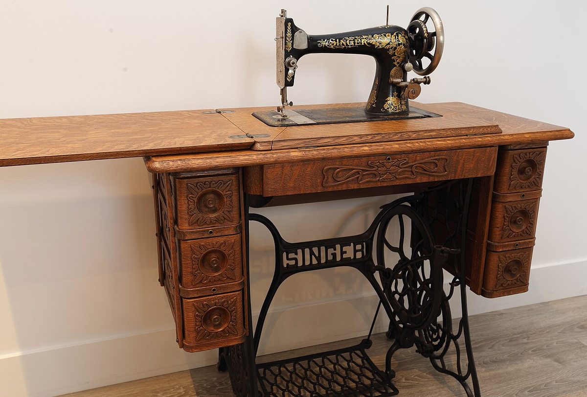 A 1910 Singer Model 27 in its oak treadle cabinet, still set up for foot power. Not the one in the story.