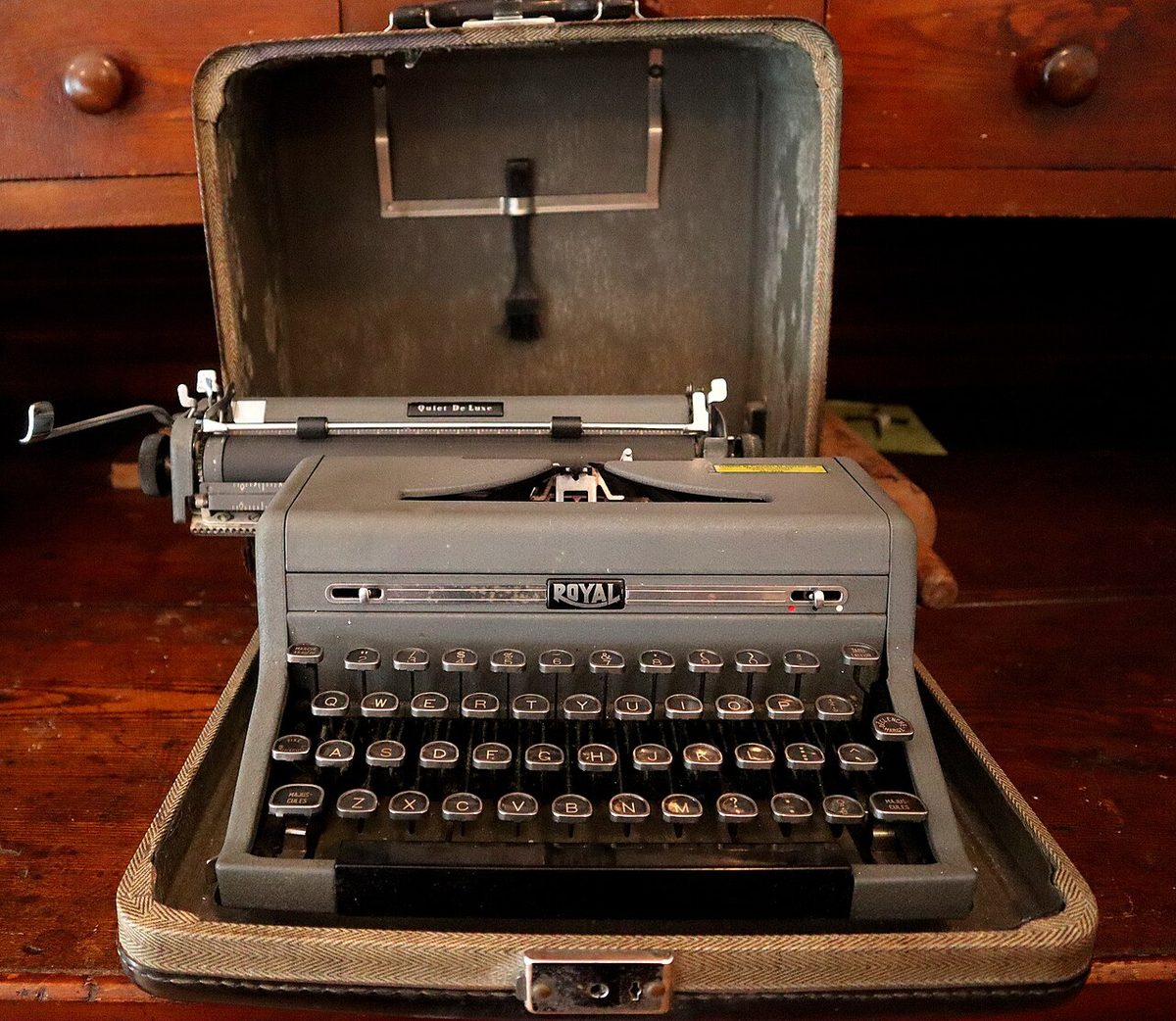 A Royal Quiet De Luxe portable typewriter in its carrying case, in a museum. Not the one in the story.