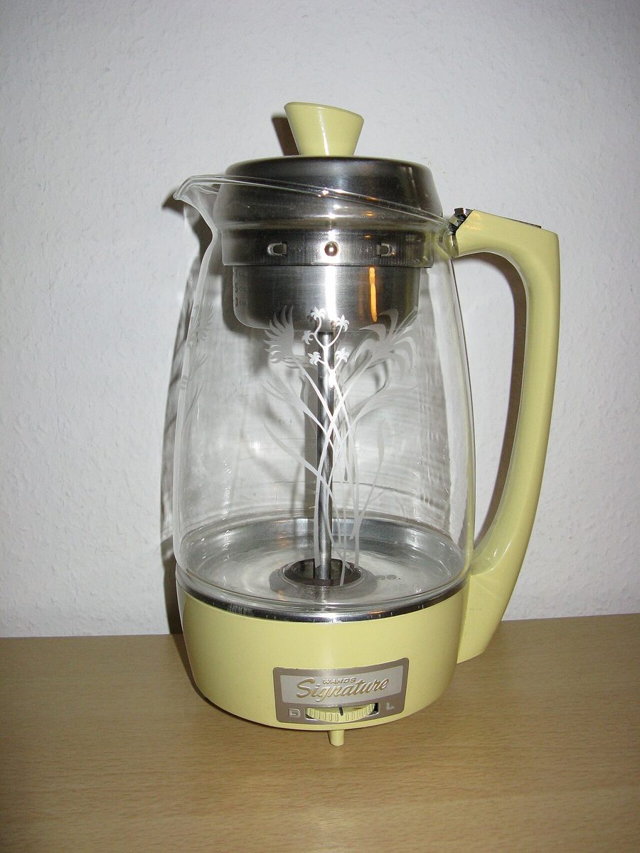 An American electric coffee percolator from around 1950, with the glass pot showing the pump tube and basket inside. Not a Hoover, and not the one in the story.